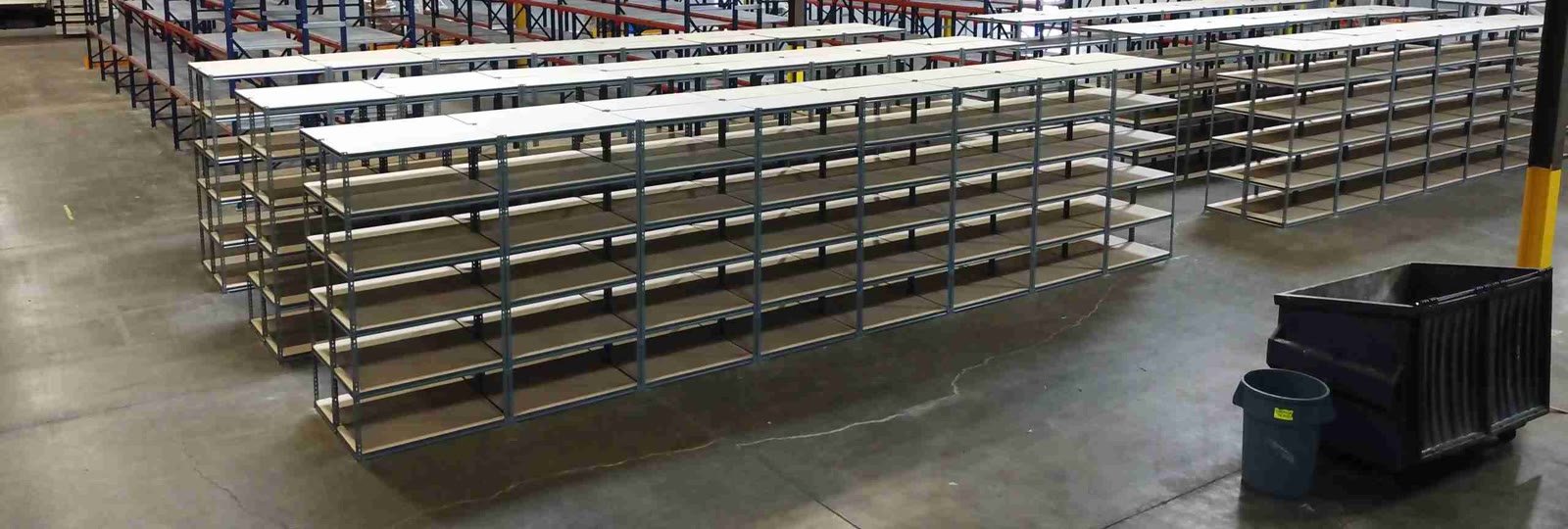 Rows of installed boltless shelving with individual shelf levels in a warehouse